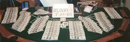 A picture of Casino table covered with Dollar bills and cards -- 10,000 7-29-03 AP