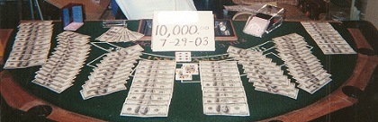 A picture of Casino table covered with Dollar bills  and cards -- 10,000 7-29-03 AP